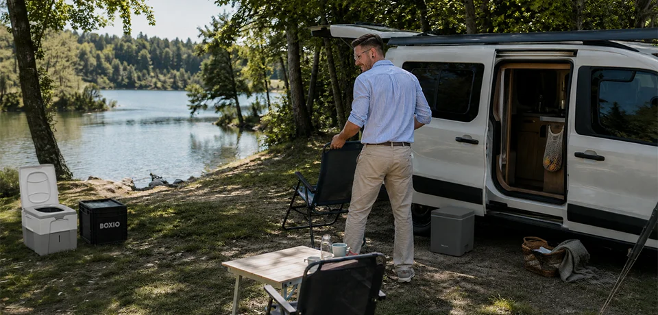 Leon at his camper van at a forest campsite